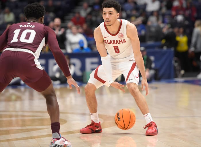 Mar 10, 2023; Nashville, TN, USA; Alabama Crimson Tide guard Jahvon Quinerly (5) dribbles as Mississippi State Bulldogs guard Dashawn Davis (10) guards during the second half at Bridgestone Arena. Mandatory Credit: Steve Roberts-USA TODAY Sports